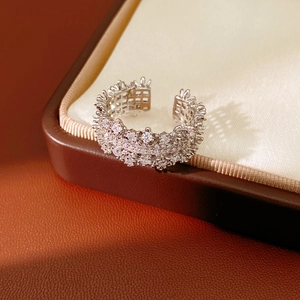 Macro shot of silver floral ring with cubic zirconia on a luxury jewelry box