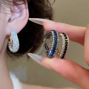 Detailed view of silver hoop earrings with micro-paved cubic zirconia in various colors