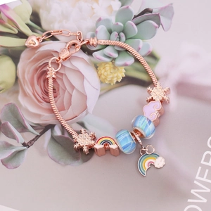 Rose gold snake chain bracelet with colorful glass beads and rainbow charms