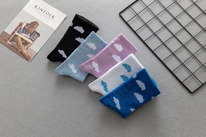 Close-up of five pairs colorful knit socks with cloud patterns and ribbed cuffs