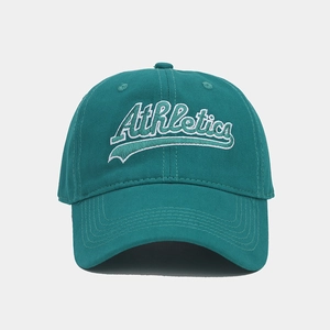Detailed close-up of white Athletics embroidery on a dark green vintage baseball cap