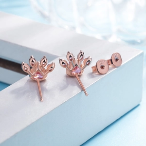 Detailed macro of S925 rose gold cat paw earrings with pink heart stones and 925 stamp