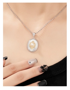 Detailed close-up of 925 silver necklace with pearl flower pendant on a model