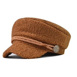 Detail of caramel teddy fleece newsboy cap with woven rope and vintage metal button