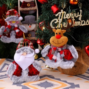Christmas plush ornaments with Santa and reindeer on a tree, festive home holiday decor