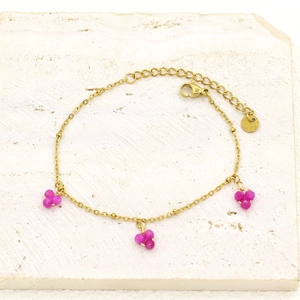 Detail of gold-plated stainless steel chain with pink stone triangle charms and lobster clasp