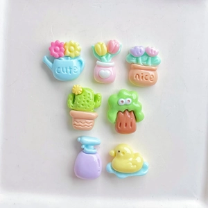 Flat lay of colorful resin mini flower pots and duck figurines for DIY crafts