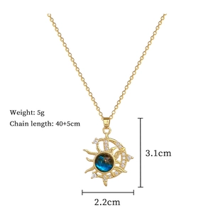 Detail of gold star and moon necklace with blue celestial stone and clear crystals