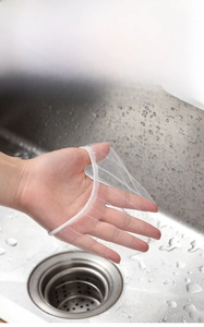 Elastic high-density sink strainer bag showing strong stretchability over a stainless steel sink