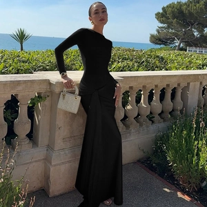 Detail view of the waist knot and pleated design on this elegant black long-sleeve maxi dress