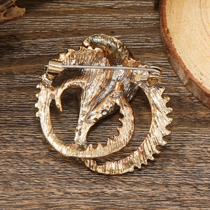 Macro shot of the vintage gold brooch back featuring a secure silver pin fastener