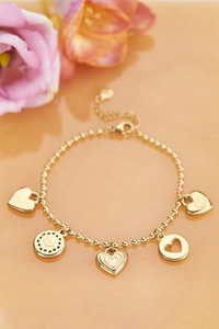 Detailed view of 18K gold plated bead bracelet featuring heart pendants with LOVE engraving