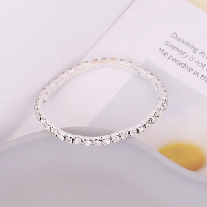 Detailed close-up of a silver rhinestone bracelet with sparkling zircon on ceramic
