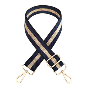 Close-up of adjustable navy blue shoulder strap with gold stripes and lobster clasps