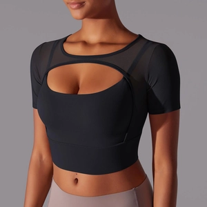 Detail view of black yoga crop top with mesh stitching and front cutout design
