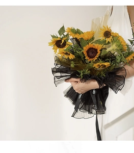 Detail view of black pleated pearl mesh wrap used for sunflower bouquet floral packaging