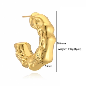 Golden C-shaped earrings with irregular lava texture finish and 28.6mm height