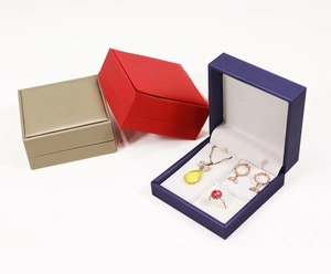 Close-up of three premium brushed leather jewelry boxes showing necklace and ring inserts