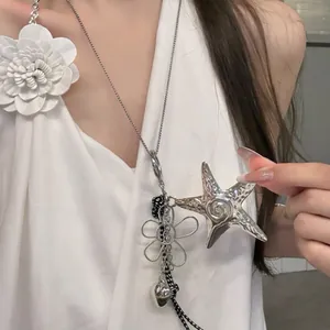 Detail of seashell ceramic necklace with starfish, heart pendants and woven cord