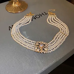 Luxurious multilayer pearl choker necklace with a vintage sparkling crystal center piece