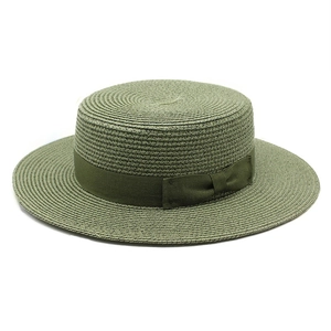Detailed texture of flat top straw boater hat with matching olive green ribbon bow