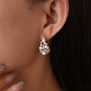 Vintage pearl basket hoop earrings with rhinestones on a female model closeup