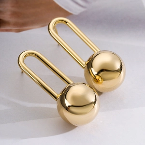 Modern minimalist gold sphere drop earrings with U-shaped hooks and metallic finish