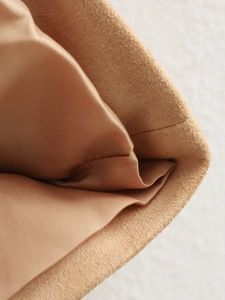 Macro view of brown suede fabric texture and durable inner lining stitching details