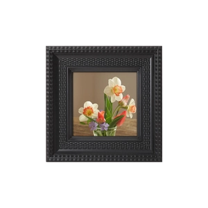 Square black vintage photo frame with textured layers and a colorful floral art print