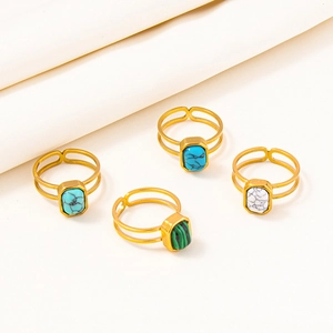 Detail of adjustable double-layered gold rings featuring blue, green, and white stone inlays