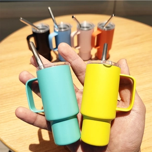 Close-up of mini stainless steel mugs with handles and straws in various matte colors