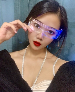 Detail of blue LED light effect and futuristic lines on cyberpunk glasses worn by model