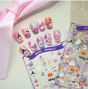 Close-up of Halloween nail stickers with pink ghost and pumpkin cartoon motifs