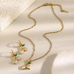 Detail of 18K gold-plated stainless steel cherry necklace and heart-shaped zircon earrings