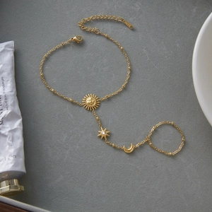 Gold stainless steel ring bracelet featuring sun moon and star charms with zircon