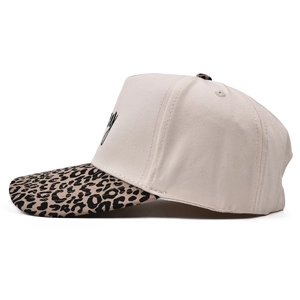 Side view of beige cotton 5-panel cap with leopard print brim and black embroidery