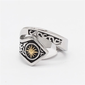 Detailed view of vintage sunburst motif and tribal engraved patterns on steel ring