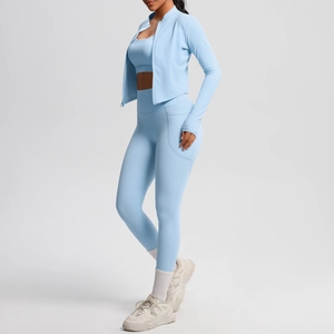 Detailed view of light blue athletic set with thumbhole jacket and side pockets yoga leggings