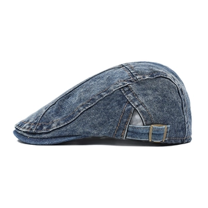 Close-up of washed denim ivy cap featuring orange contrast stitching and metal adjustment buckle