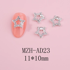 Macro detail of silver hollow star nail charms with rhinestones on pink background