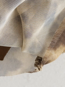 Close-up of breathable leopard print mesh fabric showing detailed texture and stitching