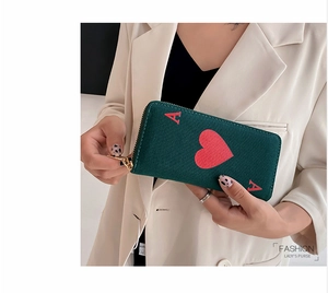 Detail of dark green canvas long wallet with Ace of Hearts design held by model