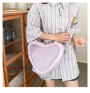 Detail view of heart-shaped lavender JK bag with mesh panel and adjustable strap