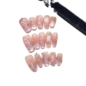 Pink cat eye press-on nails with butterfly pattern and pearl rhinestones embellishment