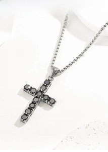 Macro detail of titanium steel cross pendant necklace with black cubic zirconia stones