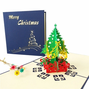 Detail of 3D pop-up Christmas tree card with red gift boxes and Merry Christmas cutout