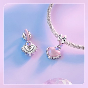 Detail of S925 silver pink heart charm with pearl trim and a delicate bow knot