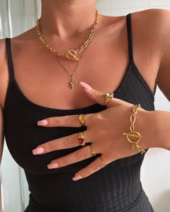 Gros plan sur l'ensemble collier en acier inoxydable plaqué or 18k avec pendentif soleil