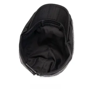 Detail showing the internal fabric lining and sweatband of the gray newsboy cap