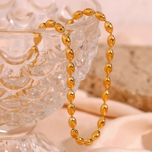 Minimalist 18K gold plated stainless steel oval bead chain necklace on a glass